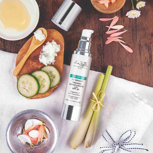 Skincare product with cucumbers and other items on a wooden table