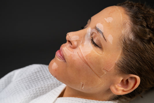 Hydrating facial mask sheet with cutouts on woman's face