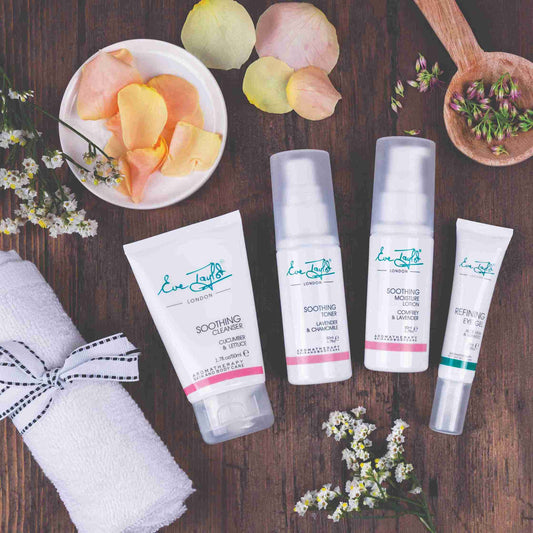 Cosmetic products on a wooden surface with flowers and petals