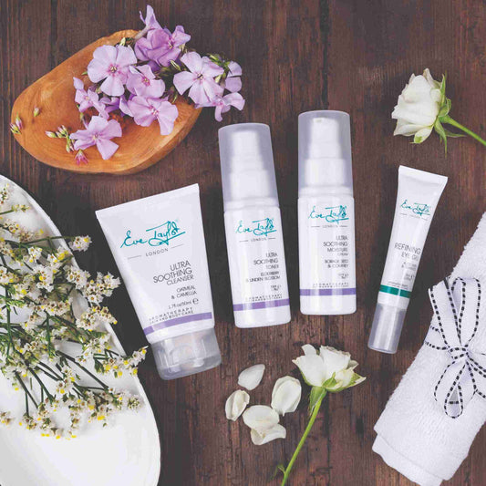 Cosmetic products with floral elements on a wooden surface