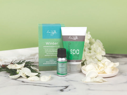 Winter aromatherapy kit with box, essential oil bottle, and white-and-green spa gel
