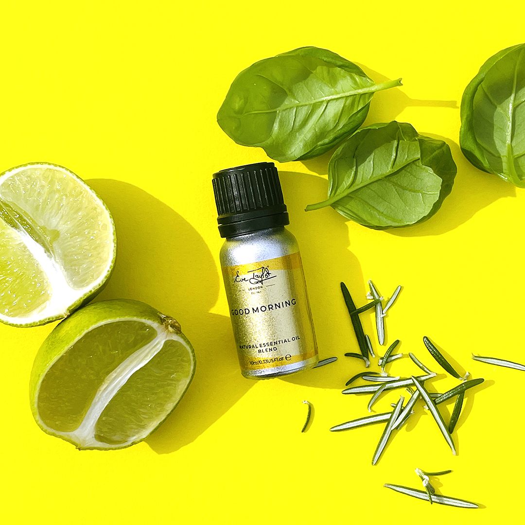 Essential oil blend bottle with lime half, leaves, and star-anise pieces