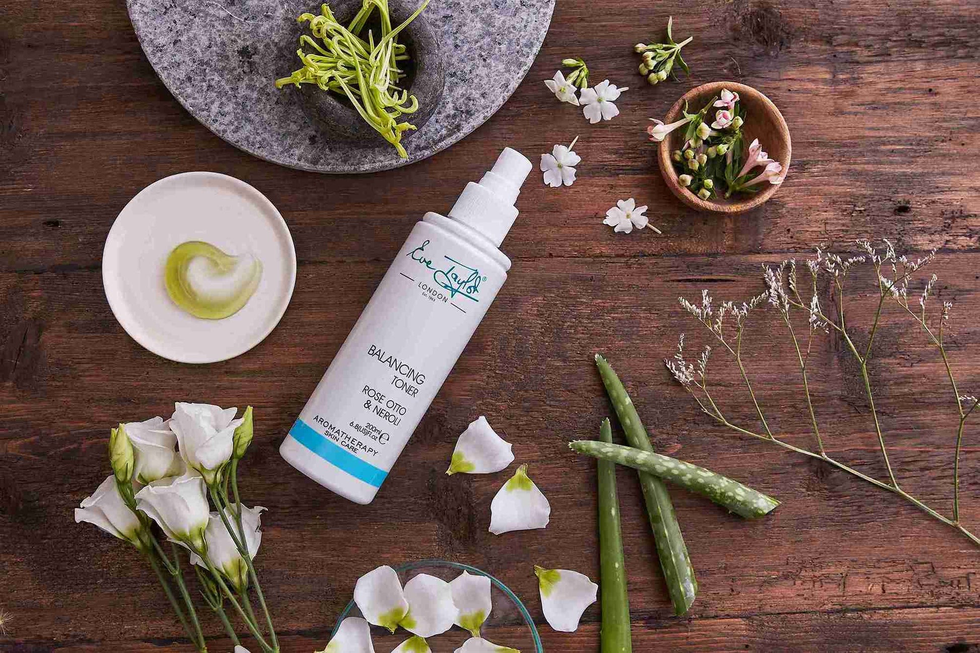 Skincare product with natural elements on a wooden surface