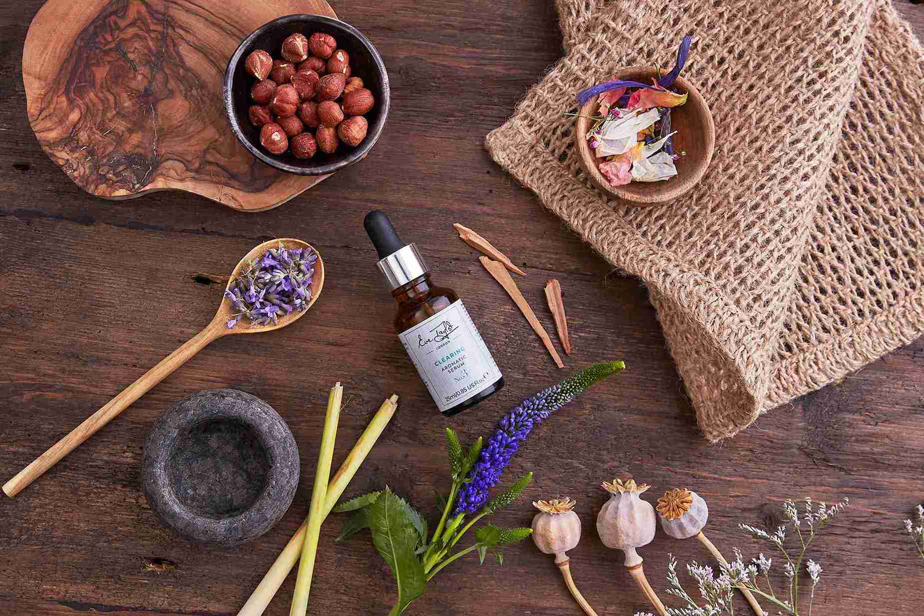 Herbal and natural products on a wooden surface with a bottle of tincture.
