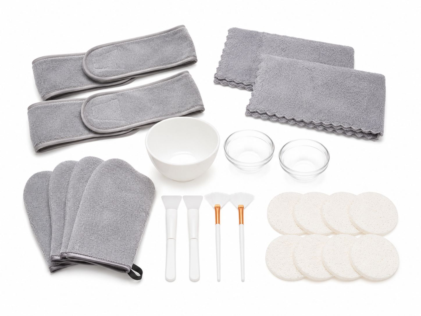 Facial ritual kit with grey headbands, facial cloths, pads, white bowls, brushes, jars