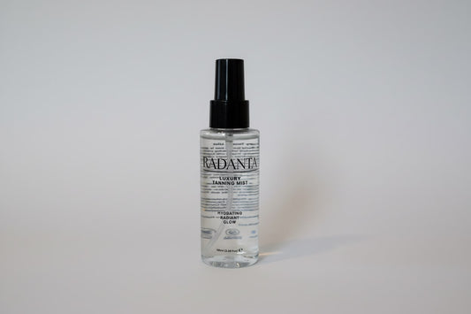 Tanning mist bottle with clear liquid and black spray pump dispenser