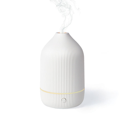 White ribbed aroma diffuser with mist outlet and gold accent band